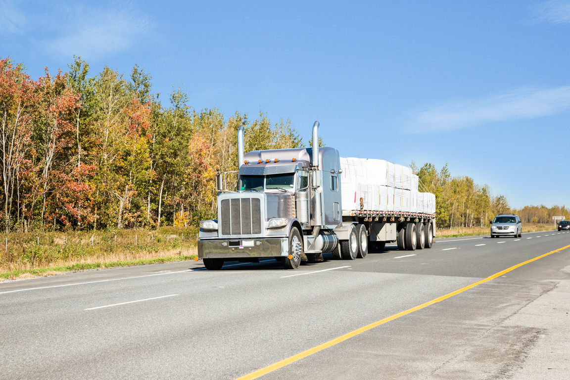 Flatbed trailer truck on a multi lane highway RM